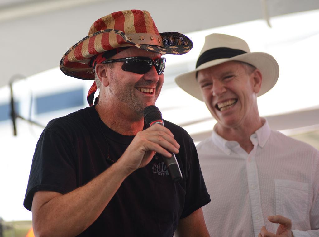 Mike Adams, left, and Dr. Kevin Staveley-O'Carroll laugh while giving a speech at the annual Paint Out Cancer fundraiser